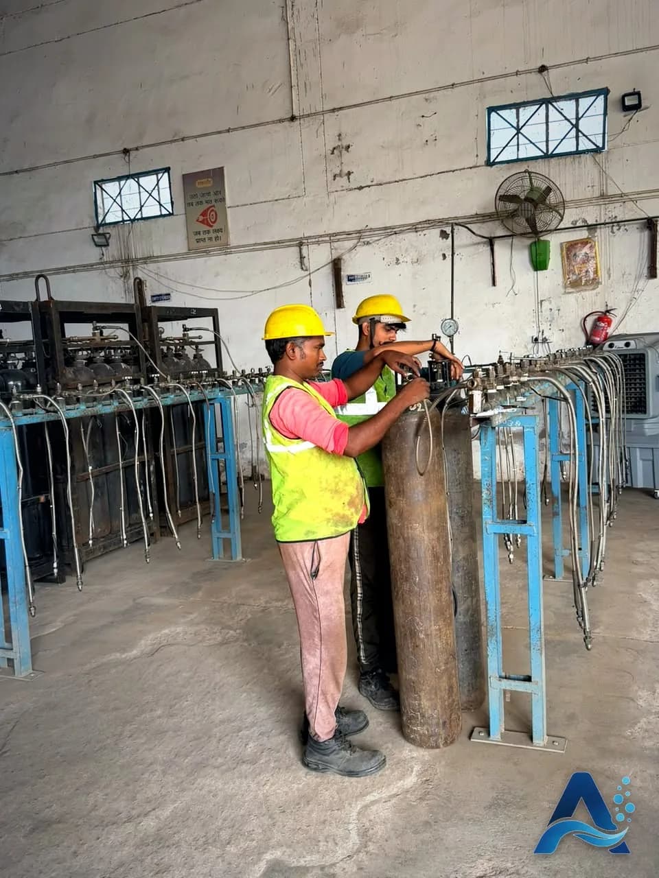 Workers in safety gear filling gas cylinders at Aggarwal Air Products